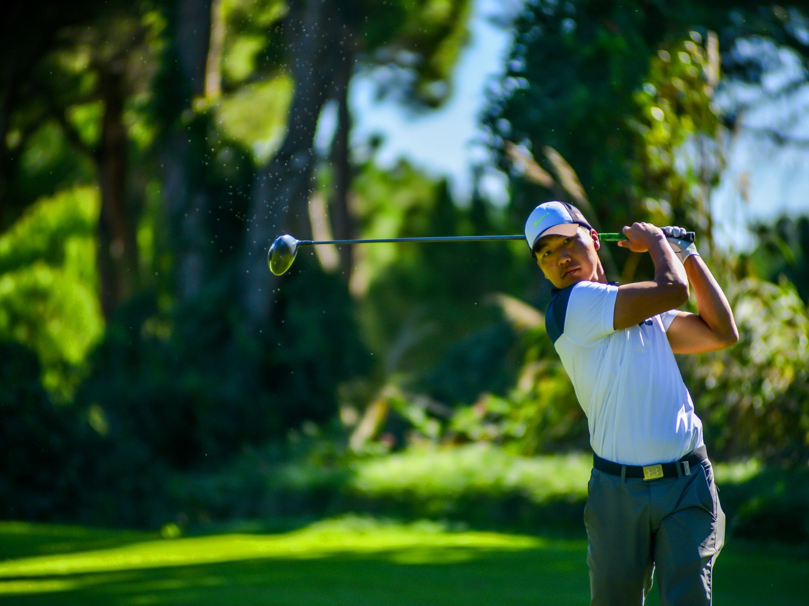 Golfer mid-swing during rotational mobility work for athletes